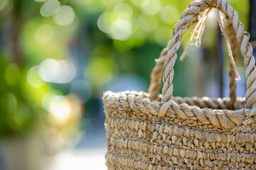 Obraz premium Close Up of Woven Bucket Bag with Blurred Nature Background