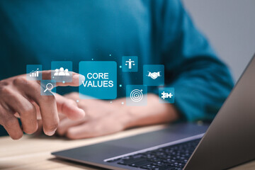 Core values responsibility ethics goals company concept. growth, business strategy and customer relations. Businessman using laptop with core values icons on virtual screen.