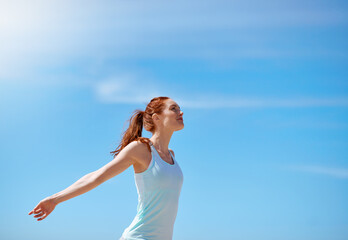 Woman, outdoor and happy with arms open for meditation or freedom to relax, break and mental health. Female person, stress relief and happy with yoga or balance for wellness, wellbeing and self care