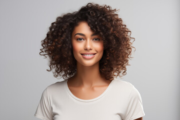 Portrait of a beautiful young woman smiling and looking at camera isolated on a white background