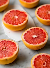 Freshly Cut Pink Grapefruit Halves on a Marble Counter