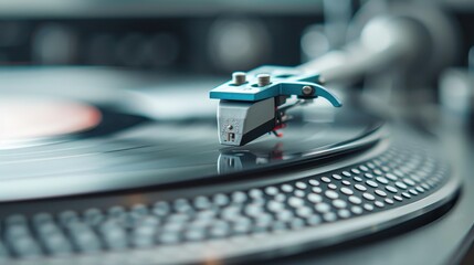 A crisp image displaying the needle or stylus on a record player as it rests on a spinning vinyl record, with a softly blurred background adding depth to the shot.