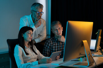 Team Of Professionals Collaborating On Computer Project In Office, Brainstorming Ideas And...