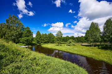 Fototapeta premium Beautiful summer river at sunny day with clouds reflection in the water