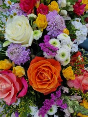 Full frame floral arrangement.A bouquet of pink and white flowers with a mix of roses and daisies. The flowers are arranged in a way that creates a sense of harmony and balance. Scene is one of beauty