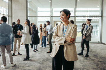 Successful businesswoman leader smiling in modern office setting with colleagues during a networking day