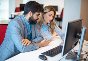 Businesswoman and businessman working on the project at office.