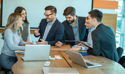 Group of coworkers interacting in the office