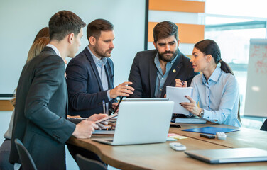Group of coworkers interacting during a business meeting in the office