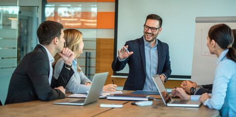 Company executive presenting new management strategy to team in conference room.