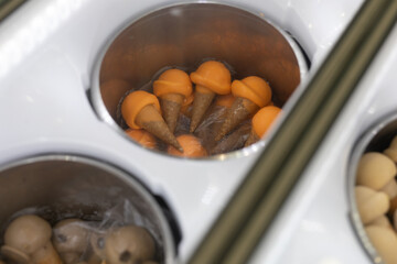 Orange and white ice cream cones in a freezer