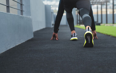 Start, runner and person with fitness, shoes and workout with race, sportswear and endurance. Closeup, legs and athlete with sneaker, beginning marathon and cardio with challenge, balance or exercise