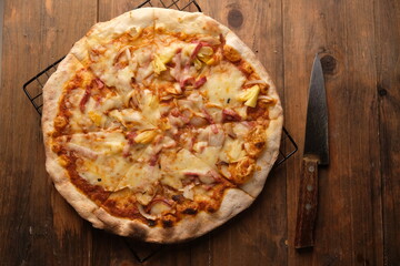 Pizza is a savory dish from Italy, a type of round, flat dough, which is baked in the oven and usually covered in tomato sauce and cheese with other additional food ingredients. 