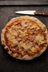 Pizza is a savory dish from Italy, a type of round, flat dough, which is baked in the oven and usually covered in tomato sauce and cheese with other additional food ingredients.