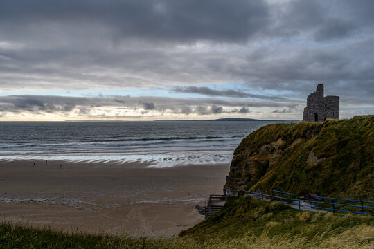 A castle ruins looking over the ocean coastline in Ireland