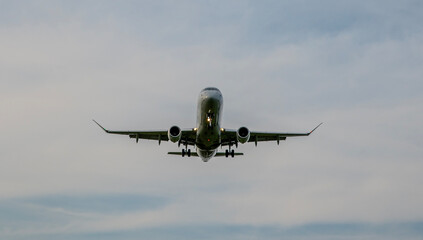 Closeup view of Plane landing at the airport with clouds