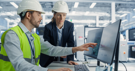 Electronics Research and Development Facility: Caucasian Female Manager Consults Male Engineer....