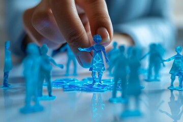 Close-up of a beautiful businesswoman's hand using AI technology to holographically protect blue paper cut out figures on a white background.