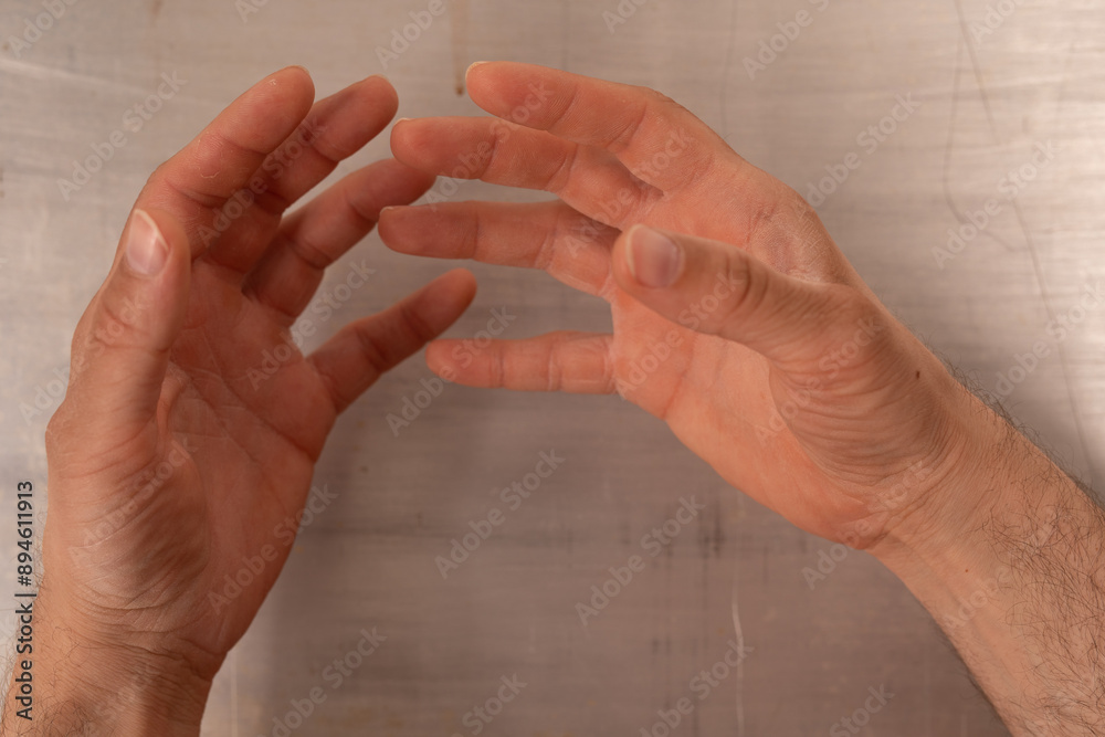 Poster two hands reach out as if to grasp something unseen