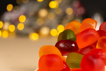 Obraz premium Christmas Gummy Colorful Candy on Garland Background.