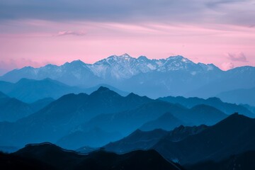 Fototapeta premium The Great Wall of China, the silhouette of snow-capped mountains in pink and blue tones at dusk, high definition photography 