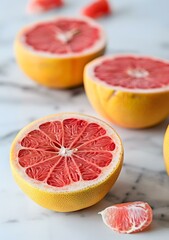 Freshly Cut Pink Grapefruit Halves On White Marble Countertop