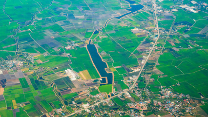 Aerial view Green paddy rice terrace land. Aerial drone shots summer tropical in summertime on sunny day amazing landscape. Agriculture rice field above view greenery background natural paddy fields