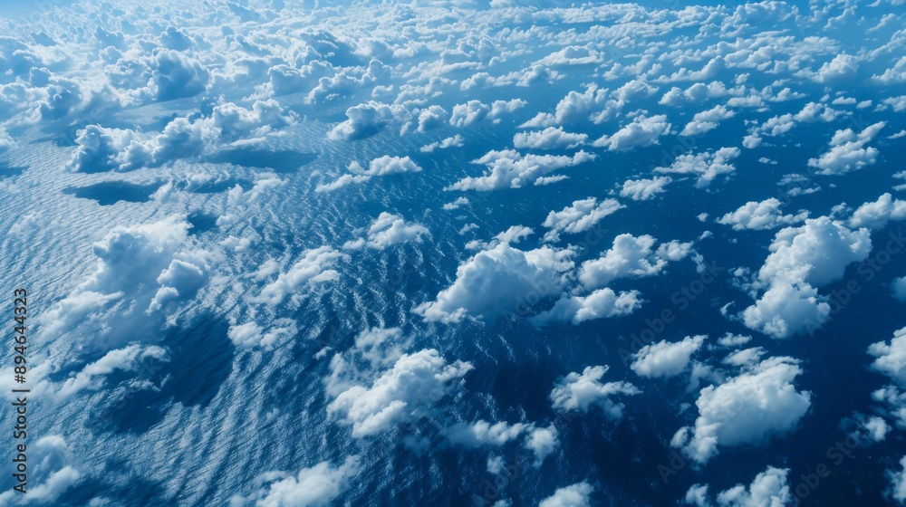 Poster Aerial view of cirrocumulus clouds forming a delicate pattern of ripples across a deep blue sky.