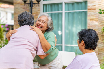 Group of Asian senior mature woman support and embracing each other during talking about life problem thoughtful with professional psychiatrist. Elderly people mental health care and therapy concept.