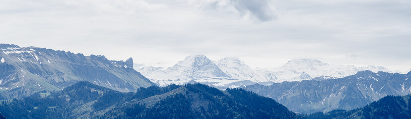 View of Eiger, Mönch, and Jungfrau Peaks in Swiss Alps in May