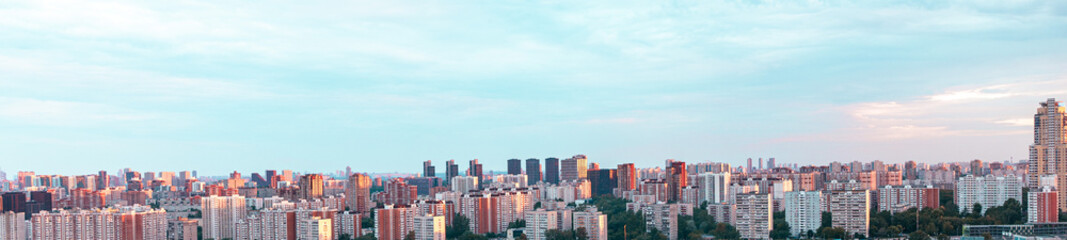 Fototapeta premium Panorama of a big city, bright blue sky. A place to copy the space.
