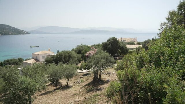 View of Ionian Sea and Paralia Mparmpati beach with hills in the background, Barbati, Corfu, The Ionian Islands, Greek Islands, Greece