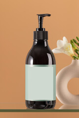 A black pump bottle with an empty label, perfect for the branding concept.