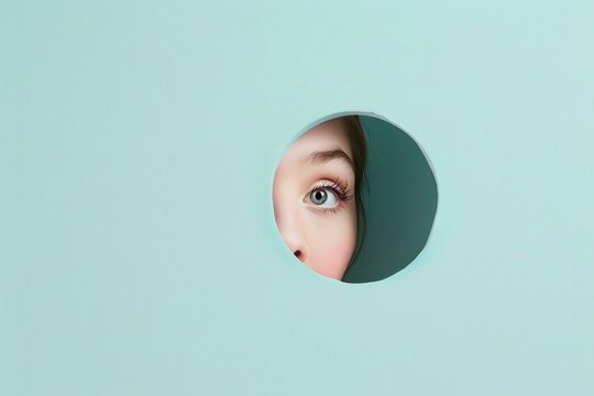 A human eyes peeking through a circle hole on a clean light color wall, concept about stalking and privacy 
