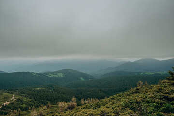 Mountain spring landscape. Overcast weather. The sky is overcast with dark clouds. Beautiful mountain landscape in spring.