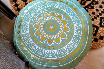 elegant oriental pillow in light green and gold colors, viewed from the top. The intricate patterns and luxurious textures are highlighted, showcasing the fine craftsmanship and rich hues