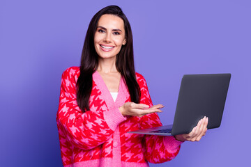 Photo of cheerful pretty lady dressed pink cardigan showing arm modern device isolated violet color background