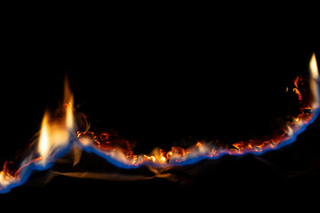 burning paper, glowing edge of paper on a black background.