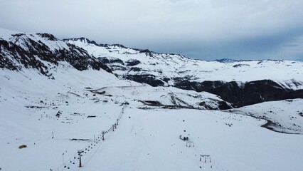 Drone view of a ski lift in a snowy ski park in the Chilean Andes, offering stunning winter views and access to pristine slopes