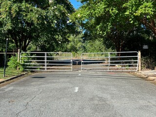 Gated and closed off entrance to an abandoned road building complex