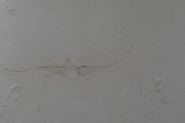 A cracked wall shows signs of wear and tear