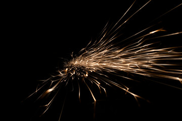 sparks from the grinder glowing in the dark