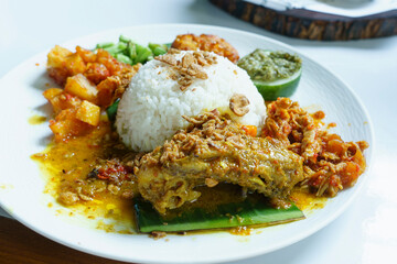 Nasi ayam campur with fragrant rice, tender chicken, and an assortment of colorful side dishes.