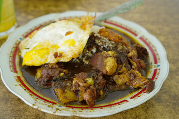 A vibrant plate of Nasi Rawon Campur.