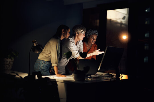 Digital agency, computer and stress at night in office for company project, diversity and late deadline. Business team, research and strategy in workplace as women with anxiety for collaboration