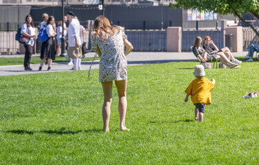 Fototapeta premium A woman and a child are playing in a park