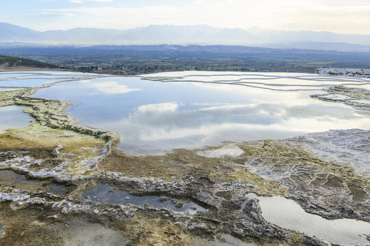 High angle and autumnal view of terraced lime roof and limestone with water of hot spring on the hill, Pamukkale, T&uuml;rkiye
