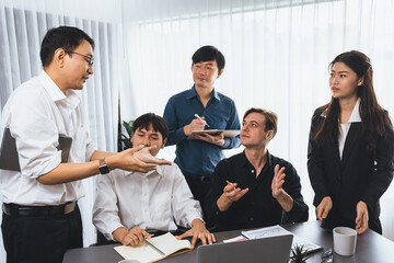 Diverse group of office worker and employee applauding, happily collaborate on strategic business marketing planning. Teamwork and positive attitude create productive and supportive workplace. Prudent