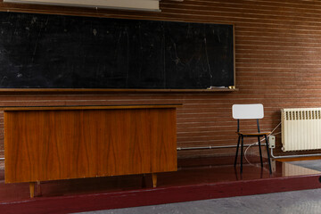 Compulsory school. University, academy, high school. Back to school. Old class, vintage love. Classroom with desk and ancient dirty blackboard, chalk, eraser. Lesson, questions, anxiety about exams. 