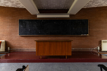 Compulsory school. University, academy, high school. Back to school. Old class, vintage love. Classroom with desk and ancient dirty blackboard, chalk, eraser. Lesson, questions, anxiety about exams. 